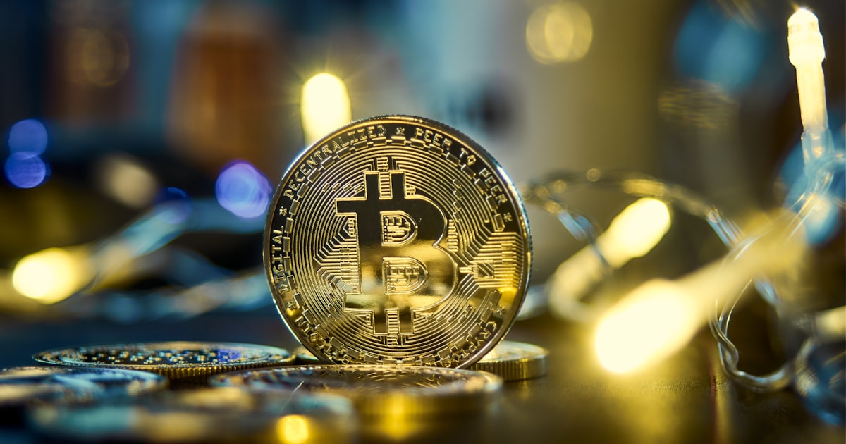 Silver and gold cryptocurrency coins arranged in a close-up editorial composition