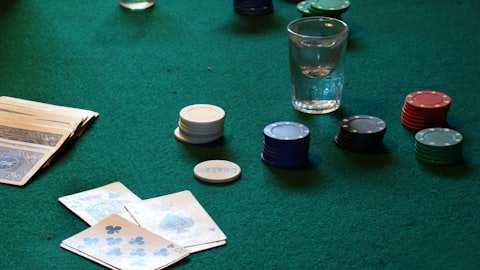 Poker chips and cards on green felt